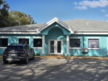 Bright turquoise building at 15120 County Line Rd in Spring Hill, FL, home of Sacred Space Yoga Studio